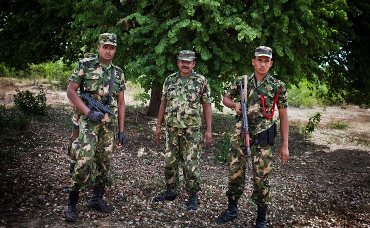 A file image of soldiers from the Sri Lankan Army standing outside official ceremonies in Kallaru village in North Sri Lanka where Australian Ambassador Kathy Klugman is opening homes for resettled Tamils. (IMAGE: Conor Ashleigh/AusAID, Department of Foreign Affairs and Trade, Flickr)
