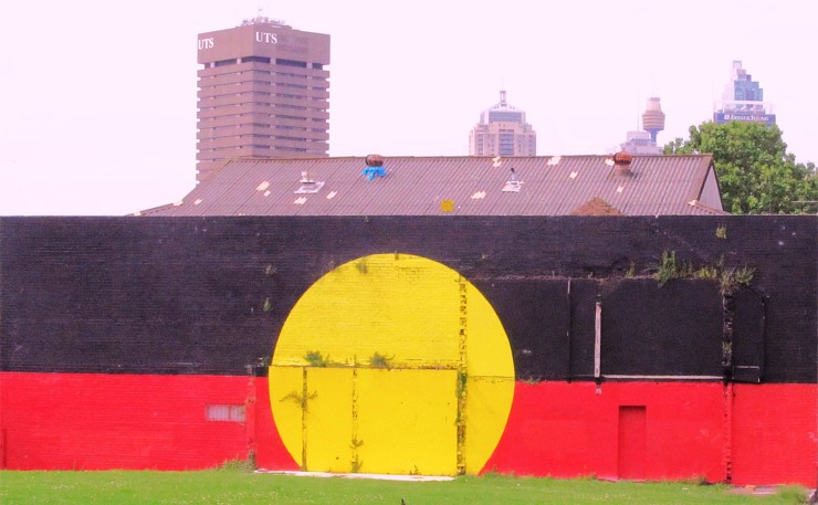 The iconic Aboriginal flag on the Tony Mundine Gym at The Block in Redfern. (IMAGE: Newtown grafitti, Flickr).