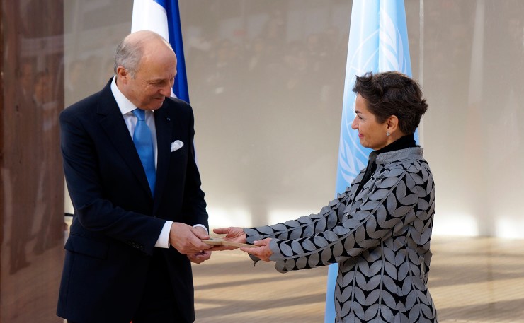 French Foreign Minister Laurant Fabius hands the keys over to the conference that will host the COP21 to the United Nation's top climate bureaucrat, Christiana Figueres. (IMAGE: Thom MItchell)