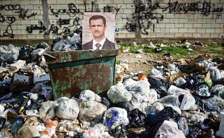 Feb. 10, 2012. A portrait of Syrian President Bashar al-Assad among the trash in al-Qsair, Syria. (IMAGE: Freedom House, Flickr) 