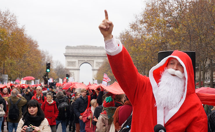 Protestors march in Paris after the announcement of the COP21 deal struck after two weeks of negotiations involving more than 200 countries. (IMAGE: Thom Mitchell, New Matilda)