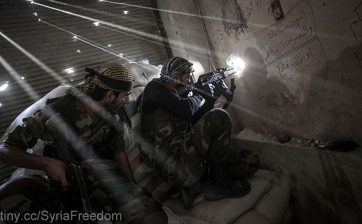 October 2012: Rebel fighters belonging to the Javata Harria Sham Qatebee watch over the enemy position during skirmishes at the first line of fire in Karmal Jabl neighborhood, district of Arkup, at the northeast of Aleppo CIty. (IMAGE: Freedom House, (Narciso Contreras/POLARIS)