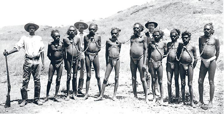 An image from the early 1900s, in Western Australia. Aboriginal 'chain gangs' were common in the remoter parts of Australia, and used to transport prisoners between towns.