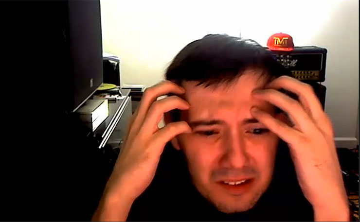 Martin Shkreli doing his webcam chat... and his level best to pretend he just lost $15 million.