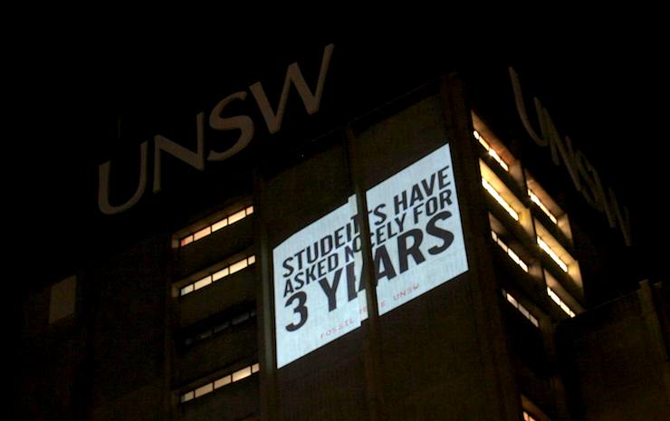 IMAGE: Fossil Free UNSW project their message onto the University tower.
