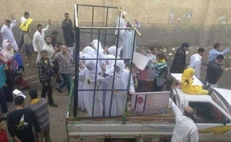 A screencap of a video showing Yazidi women being transported in cages by ISIS militants.