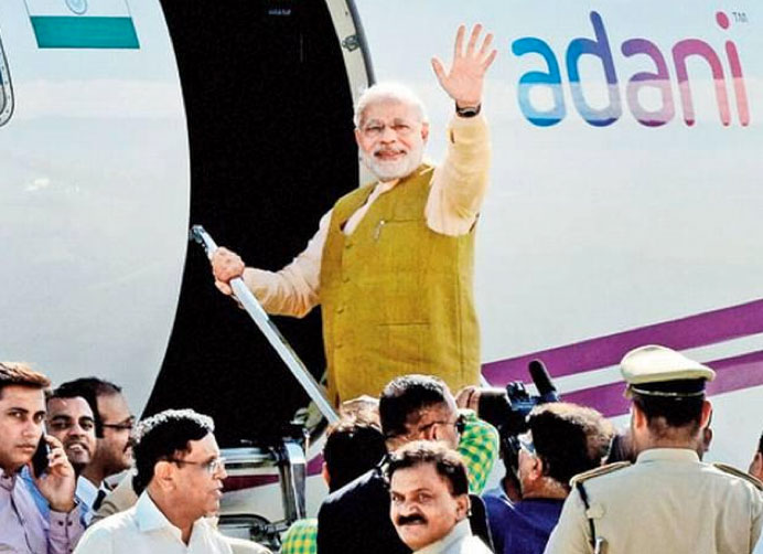 Indian Prime Minister Narendra Modi boards an Adani plane in Ahmedabad, en route to be sworn in in New Dehli, 22 September 2014. (IMAGE: ABP News).