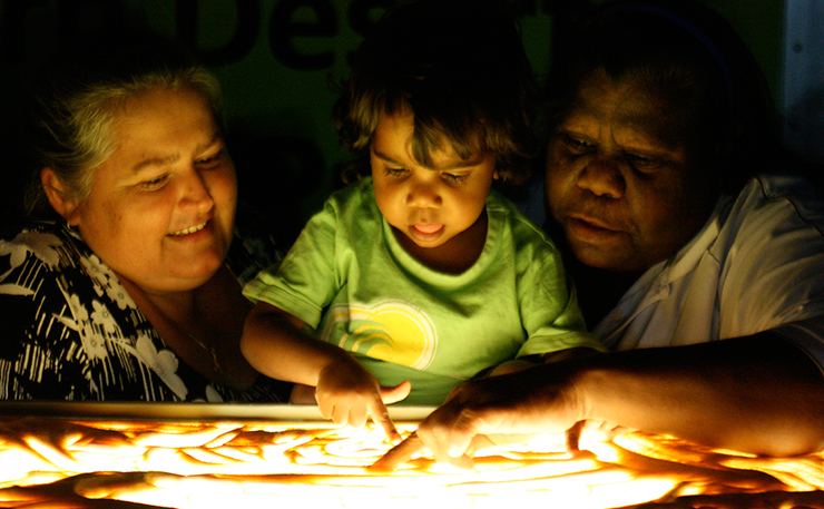Dr Christine Jeffries-Stokes and her Co-Chief Investigator, Annette Stokes showing a child the kidney health story. (IMAGE: Poppy Van Old Granger)