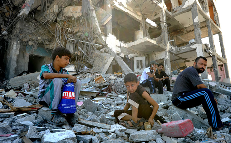 Palestinians search through the rubble of their destroyed homes hit by Israeli strikes in the northern Gaza Strip, during the 2014 assault. (IMAGE: UN Photo/Shareef Sarhan, Flickr)