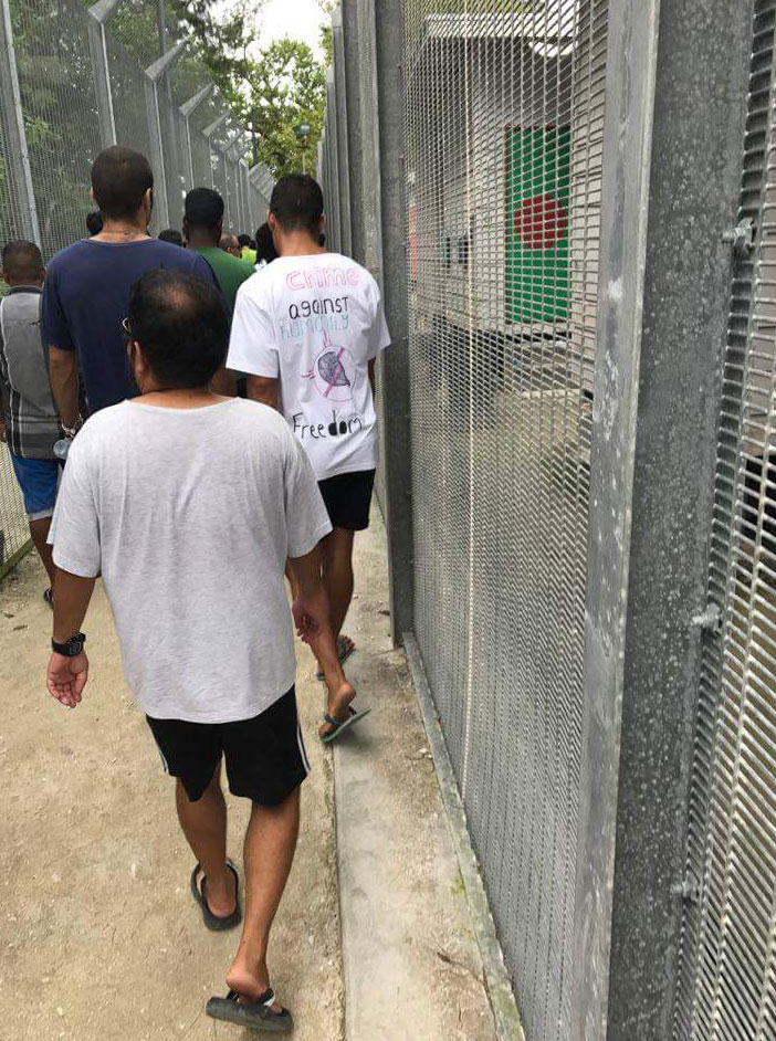 Detainees, walking in protest between compounds at the Manus Island detention centre.