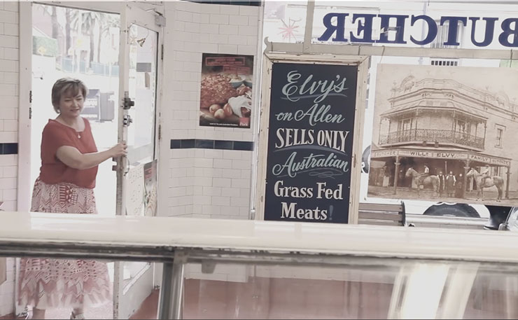 A strange woman about to have a panic attack in a butcher shop.