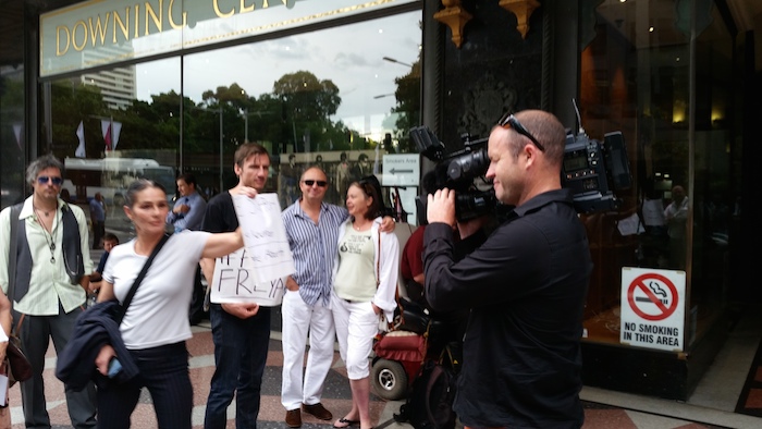 Media get friendly with protesters outside the Downing Centre. Photo: Max Chalmers.