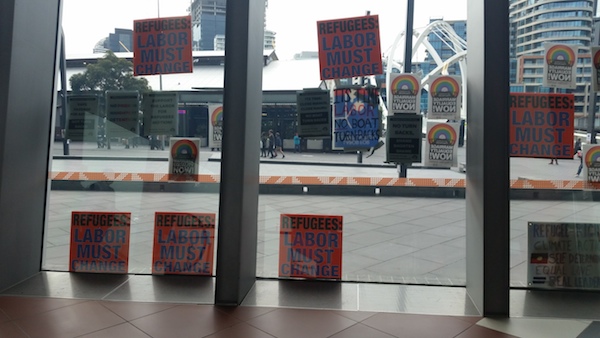 Pro refugee protesters leave placards on the walls of the convention centre