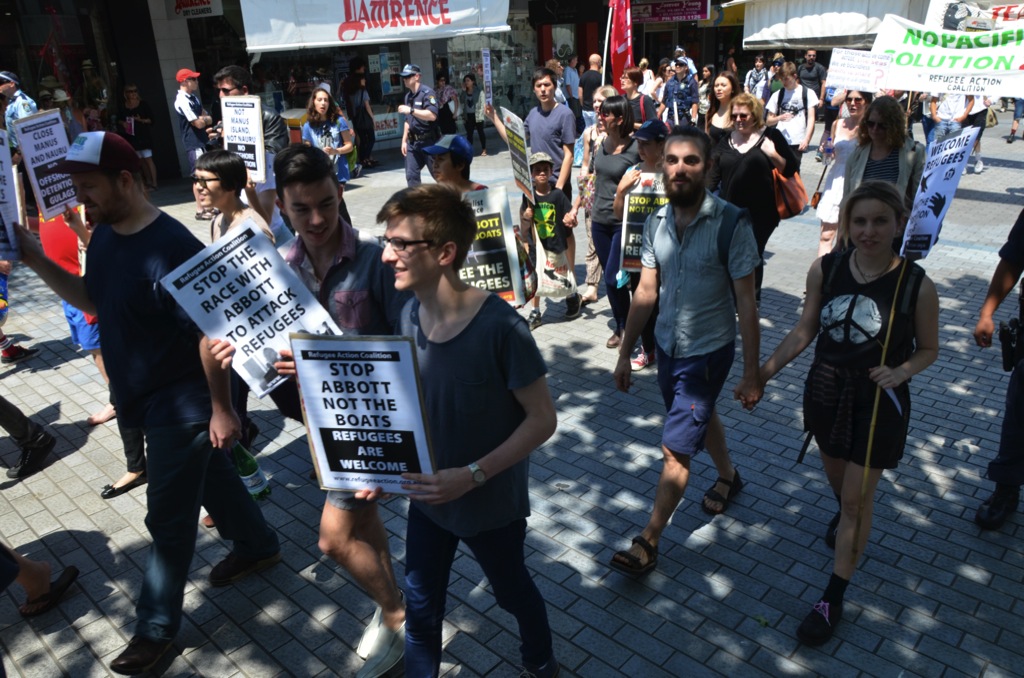 Human right supporters carrying pro-refugee signs as they march through Conulla Mall on the way to Immigration Minister Scott Morrison’s office. Photo by Paul Carson.