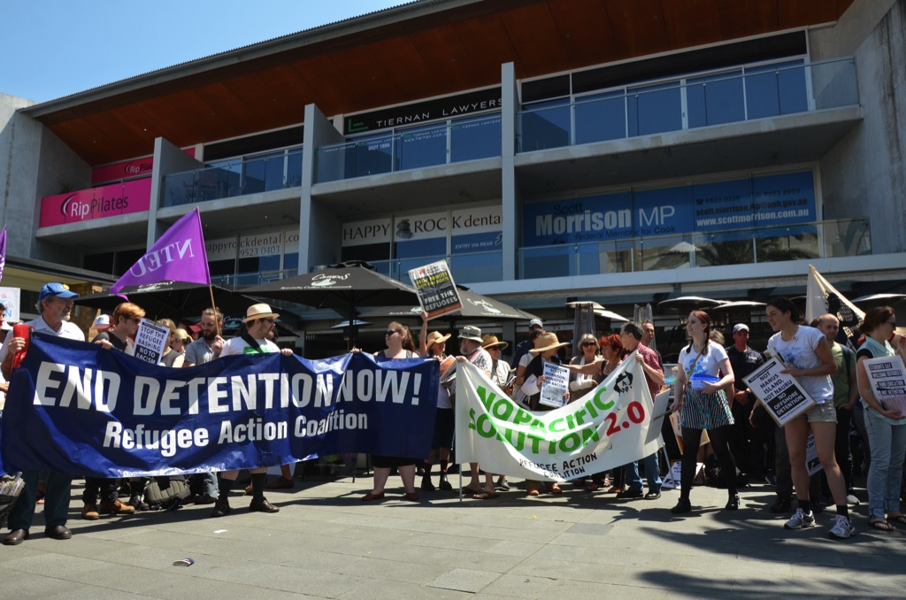 Refugee Action Coalition members and other pro-refugee supporters pose with banners and placards outside Immigration Minister Scott Morrison’s office. Photo by Paul Carson.
