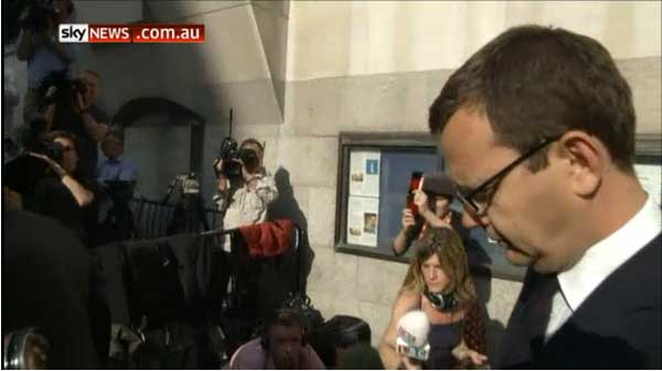 Andy Coulson is mobbed by media outside the British phone hacking trials.