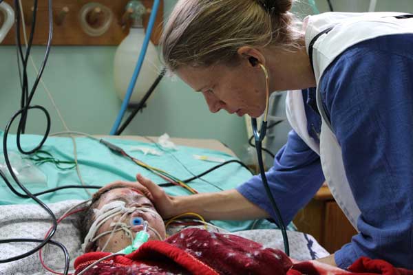 A Médecins Sans Frontières anaesthetist in the intensive care unit of the burnt service of Shifa hospital where two brothers, 8 and 4 years old, were hospitalised after being severely burned when a missile fell on their house. 