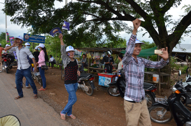 Jubilant young Cambodian National Rescue Party supporters on the roadside in provincial Battambang. Photo by Paul Carson.