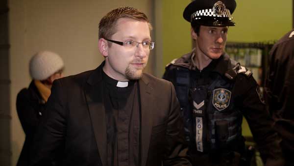 Reverend John Hughes is arrested and led from the office of Jamie Briggs MP by Mt Barker Police.