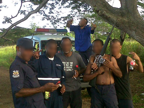 A "glory photo" of mobile squad members posing with beers and a rifle. Photo supplied.