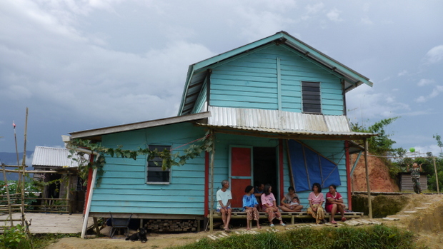 One of dozens of houses in Mukayun rebuilt, piece by piece, carried up from their former river-side village Sait. Photo by Andrew Garton.