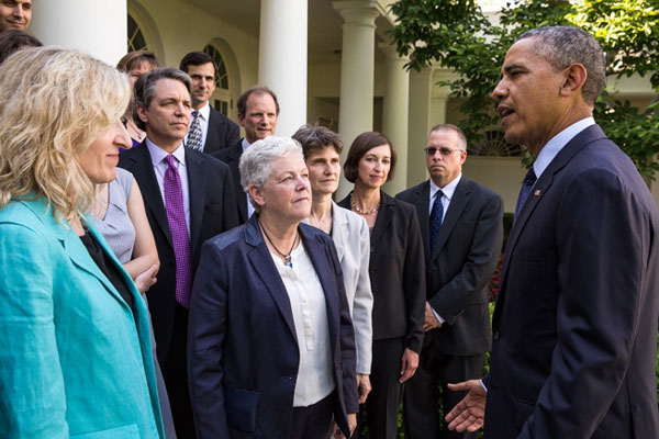 President Barack Obama, with Environmental Protection Agency Administrator Gina McCarthy, center, talks with EPA staff members who worked on the power-plant emissions standards, in the Rose Garden of the White House, June 2, 2014. (Official White House Photo by Pete Souza)