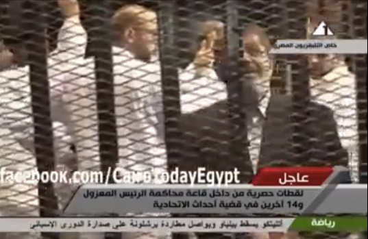 Morsi caged in the courtroom.