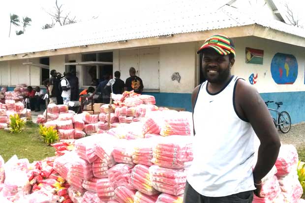 Paurie Kalondas from Eton Village on Efate lining up to receive food aid to take back to his village.