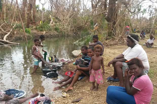 Women at Epau village, Efate do the washing in the river.