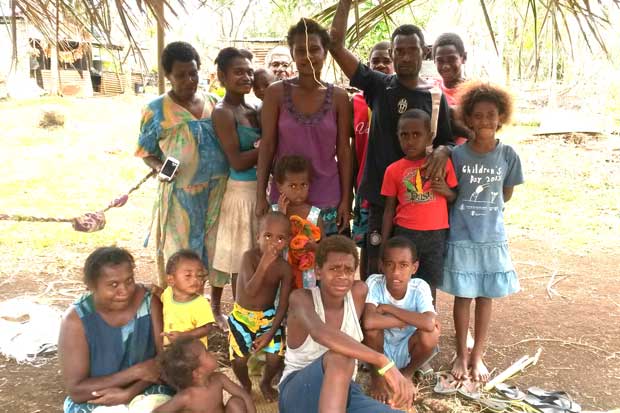 Michel Lui and his family under their shelter at Betel Village, Efate.