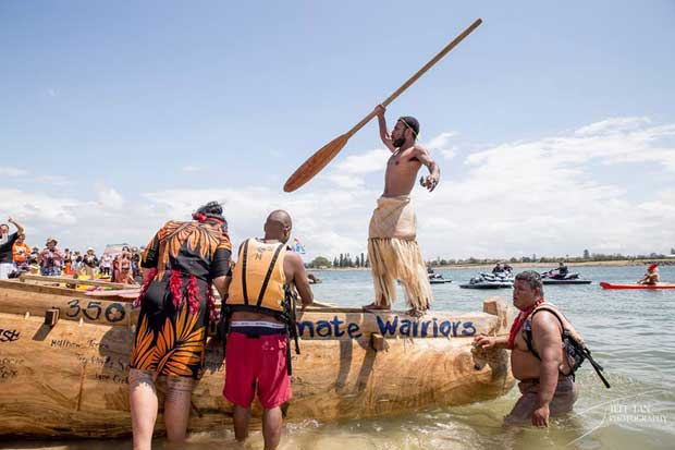 Isso Nihmei, standing in canoe… he's pleading with Australians to start acting on climate change.