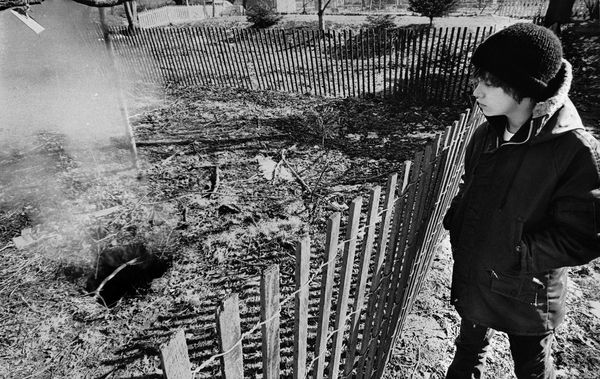 A young man in Centralia overlooks the sinkhole he fell into, after the mine fire caused it to open