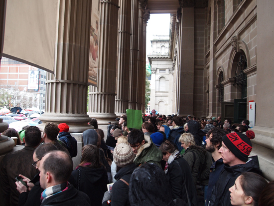 Protestors escape the rain at the Melbourne rally. Photo by Adam Brereton.